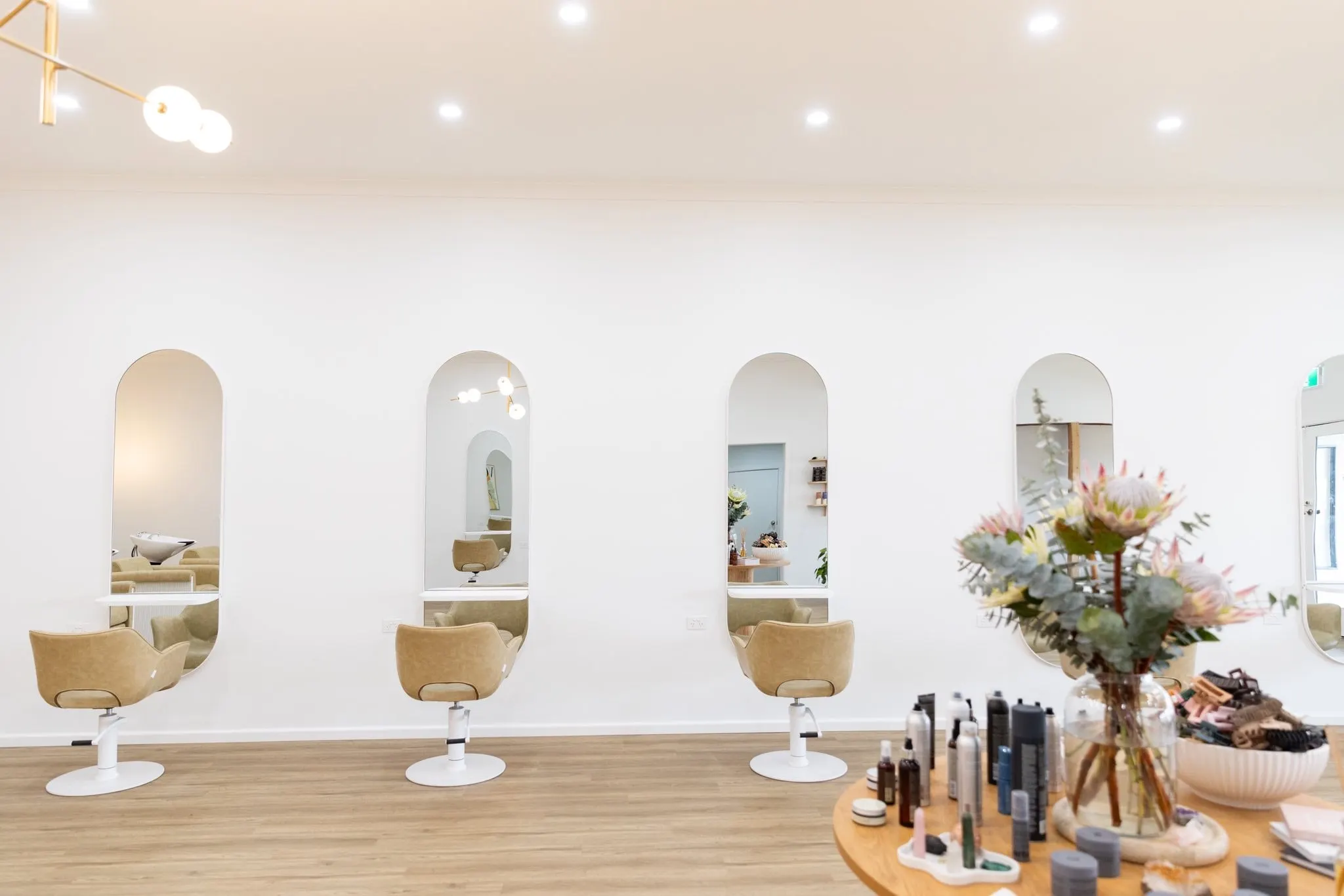 Bespoke styling stations with arched mirrors and leather chairs for customised hair services at Ergo and Mane Bridgewater